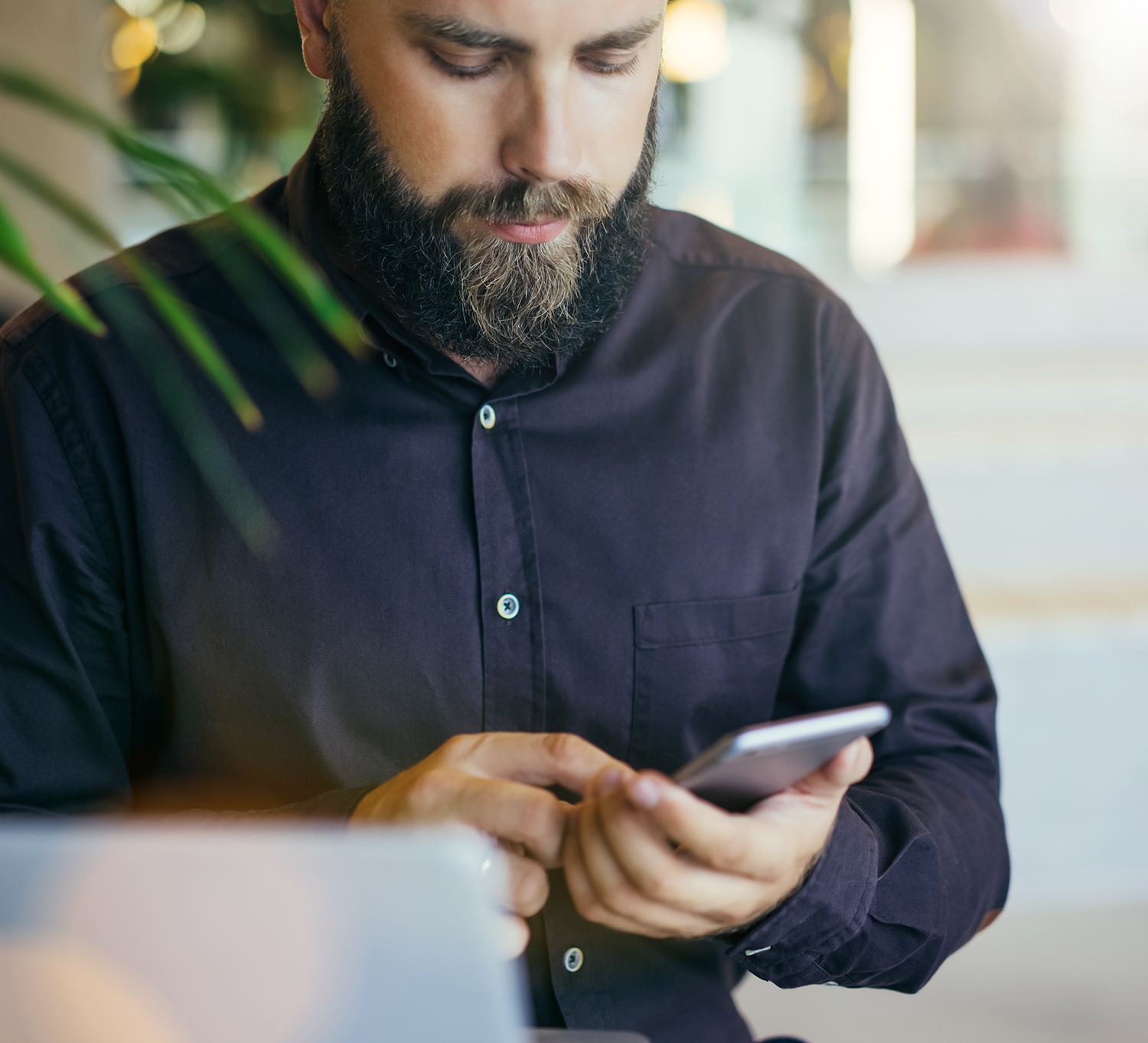 Bearded man using smartphone